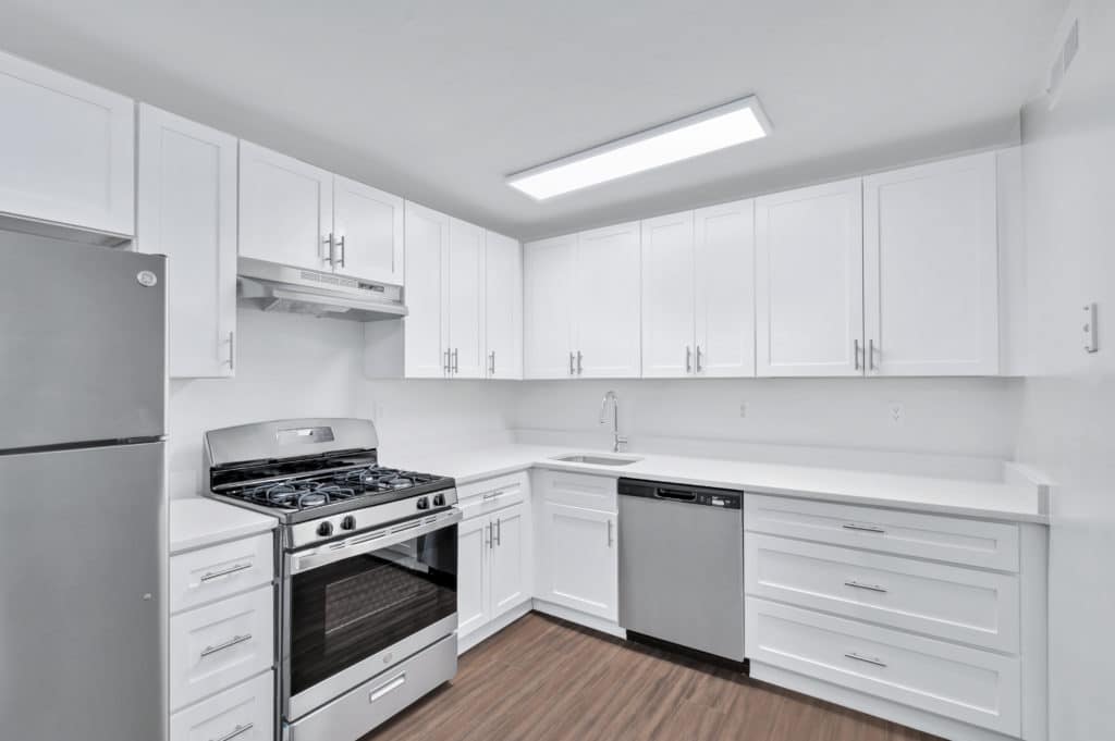 kitchen with white cabinets and stainless steel appliances | spark charlottesville apartments